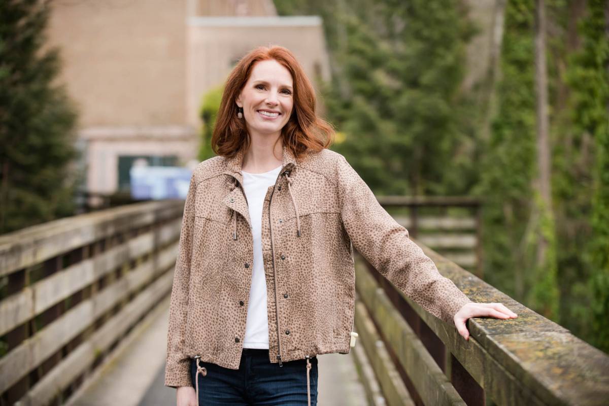 Camilla Burgess inviting clients at a bridge in Vancouver